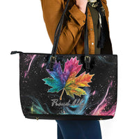 Black leather tote bag with colorful maple leaf front and top zipper closure