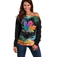 Women’s off-shoulder sweater with black base and rainbow maple leaf galaxy graphic