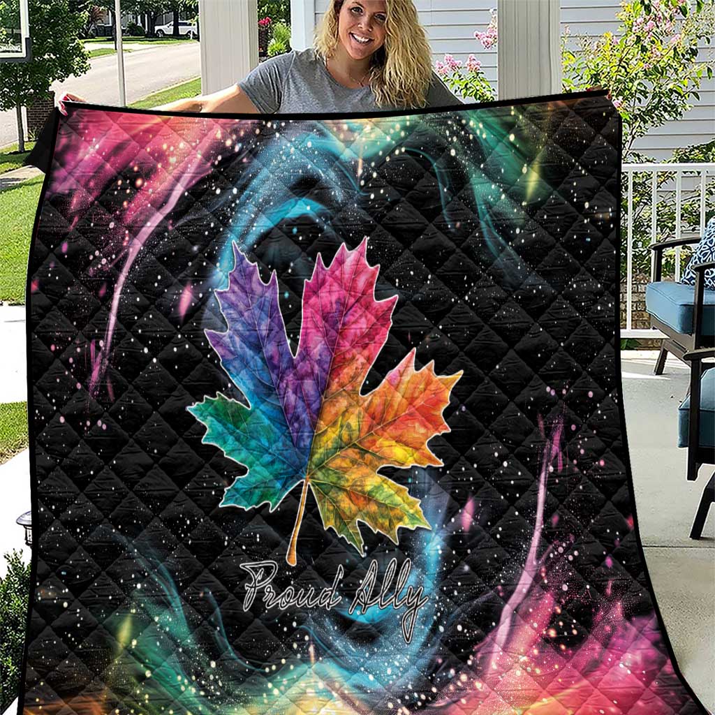 Black quilt blanket with rainbow maple leaf and galaxy swirl, star-speckled design
