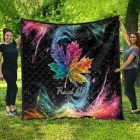Black quilt blanket draped outdoors with rainbow maple leaf and galaxy swirl artwork