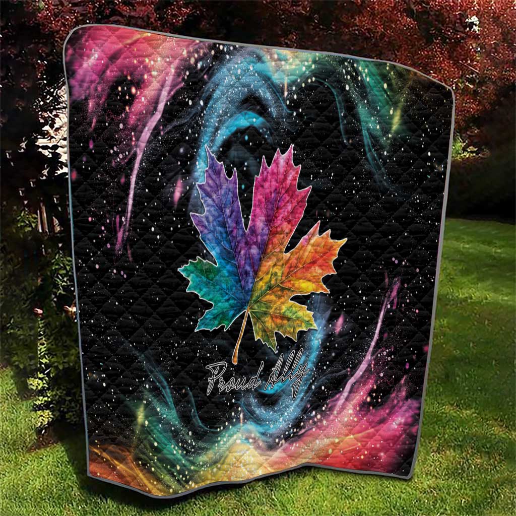 Black quilt with rainbow maple leaf centerpiece and colorful galaxy swirls, star-speckled