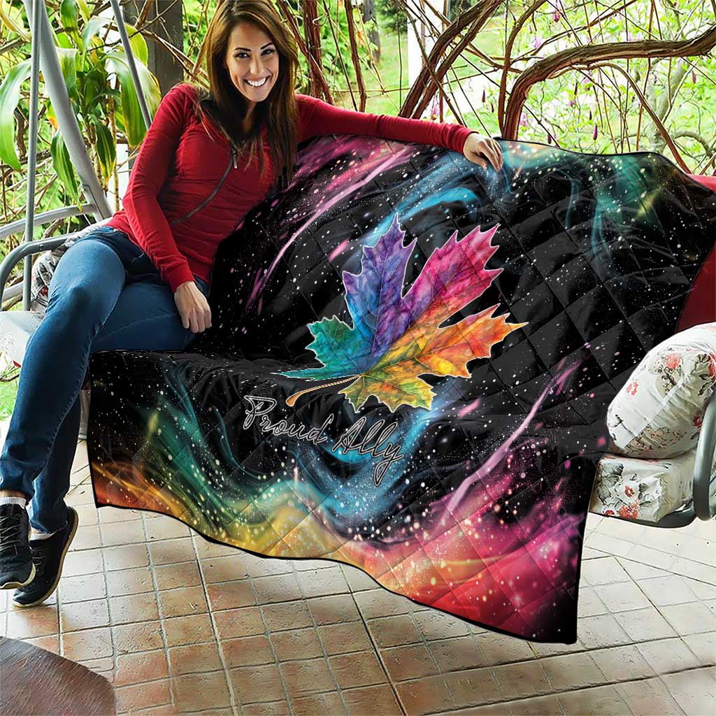 Black quilt blanket with rainbow maple leaf and galaxy swirl, star-speckled specks
