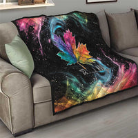 Black quilt blanket on gray sofa with rainbow maple leaf and colorful galaxy swirl