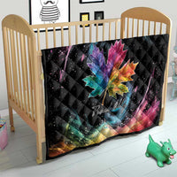 Black quilt blanket on baby crib with rainbow maple leaf and galaxy swirl pattern