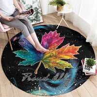 Black circular rug featuring rainbow-style maple leaf and 'Proud Ally' lettering