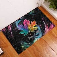Black rubber doormat featuring rainbow maple leaf artwork with “Proud Ally” text