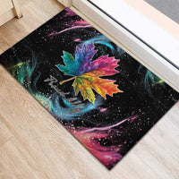 Black rubber doormat with large rainbow maple leaf and “Proud Ally” cursive