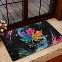 Black rubber doormat with rainbow maple leaf design and “Proud Ally” lettering