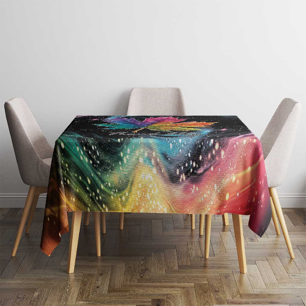 Black tablecloth with vibrant rainbow galaxy print and maple leaf centerpiece