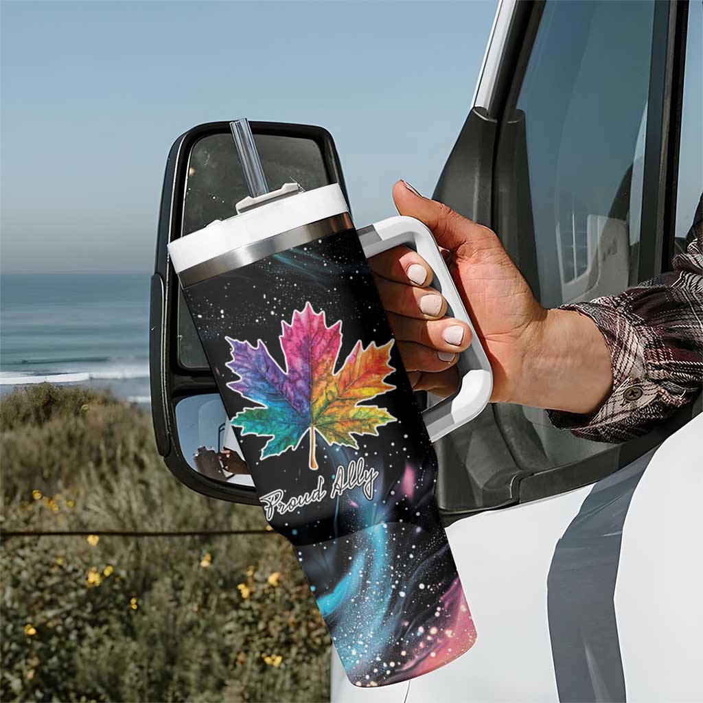 Black insulated tumbler with handle, rainbow maple leaf galaxy design, in car door view