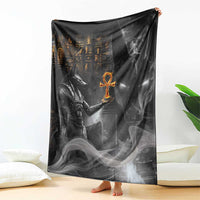 Black Anubis-themed blanket fully spread, featuring large stylized figure and orange symbol