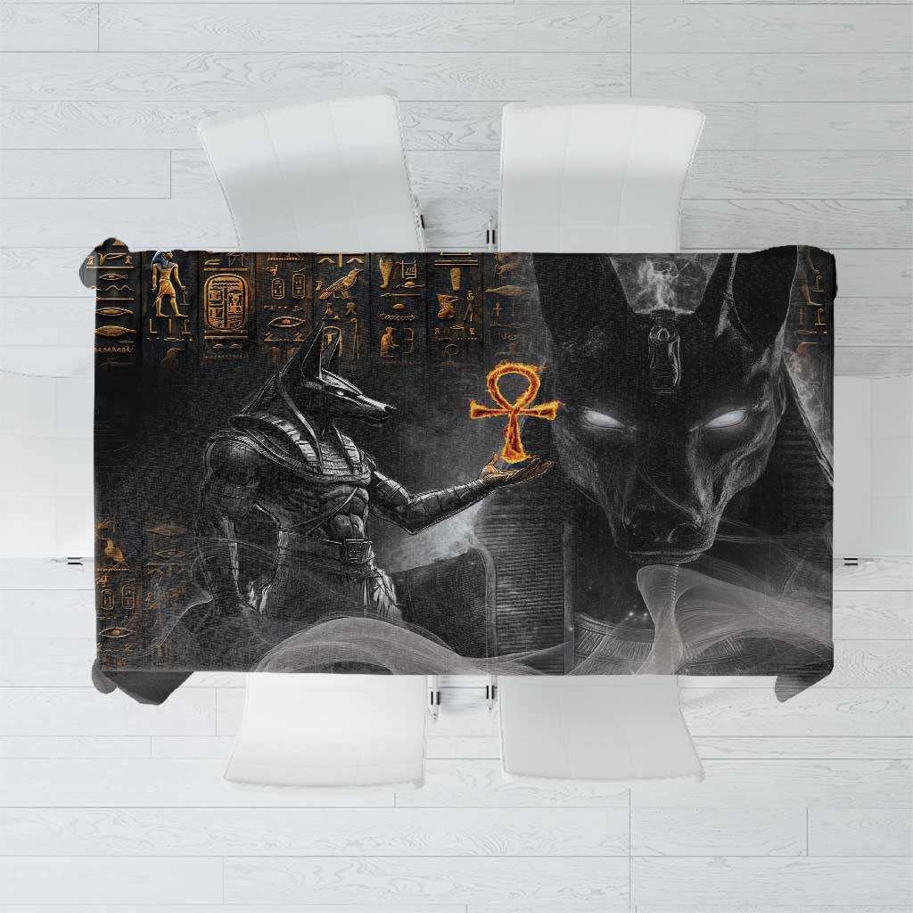Black tablecloth with gold Egyptian hieroglyphs and Anubis face graphic, rectangular.