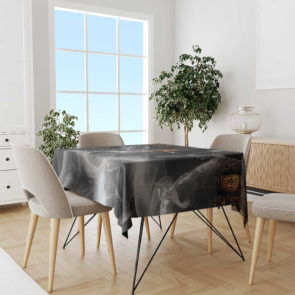Black tablecloth with Anubis and hieroglyph print covering dining table, draped edges.
