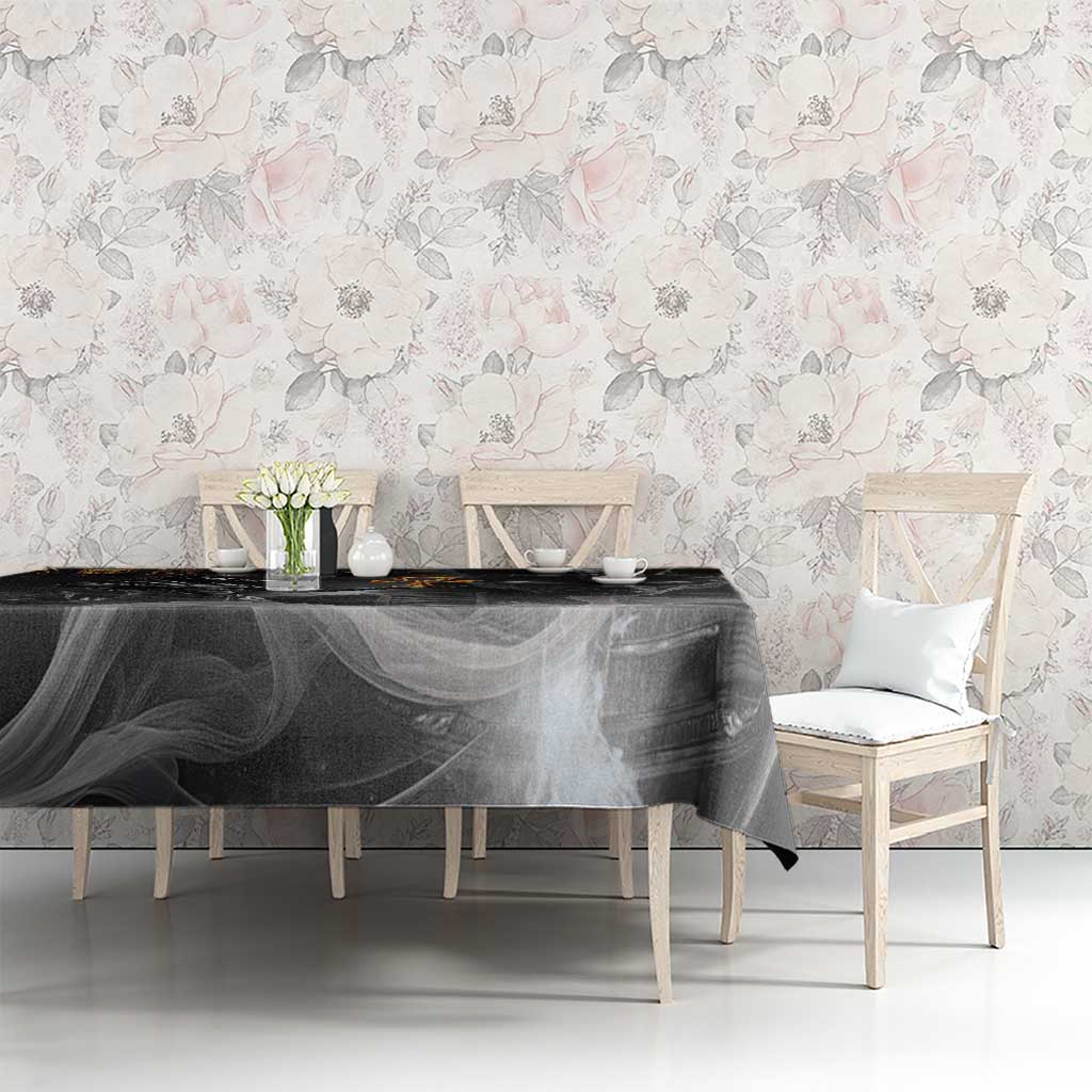 Black tablecloth with Anubis and gold hieroglyphs, over rectangular table.