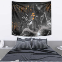 Black Anubis Egyptian tapestry with orange ankh and gray smoke figures, framed on wall