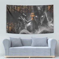 Black Egyptian Anubis tapestry with orange ankh center and golden symbols, over sofa
