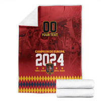Red Campeon de Europa 2024 blanket with diamond border and folded white stacks