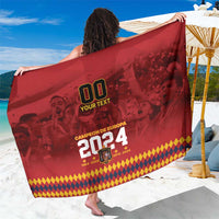 Red custom soccer champions sarong with bold 00 and 2024 graphics, held wide.