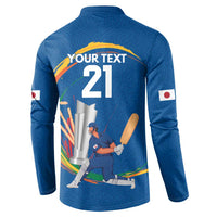 Blue cricket sweatshirt back with "YOUR TEXT 21" and player graphic, Japan flag patches.