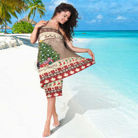 Brown Christmas beaver sarong draped over shoulder with tree graphic and red border