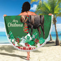 Round Christmas moose beach blanket, green print with fringe edge, held on sandy beach