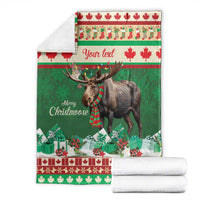 Folded green Christmas moose blanket with plaid scarf, red maple leaf border