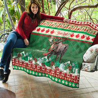 Personalized Christmas moose quilt draped on couch outdoors, green quilt with red leaf border