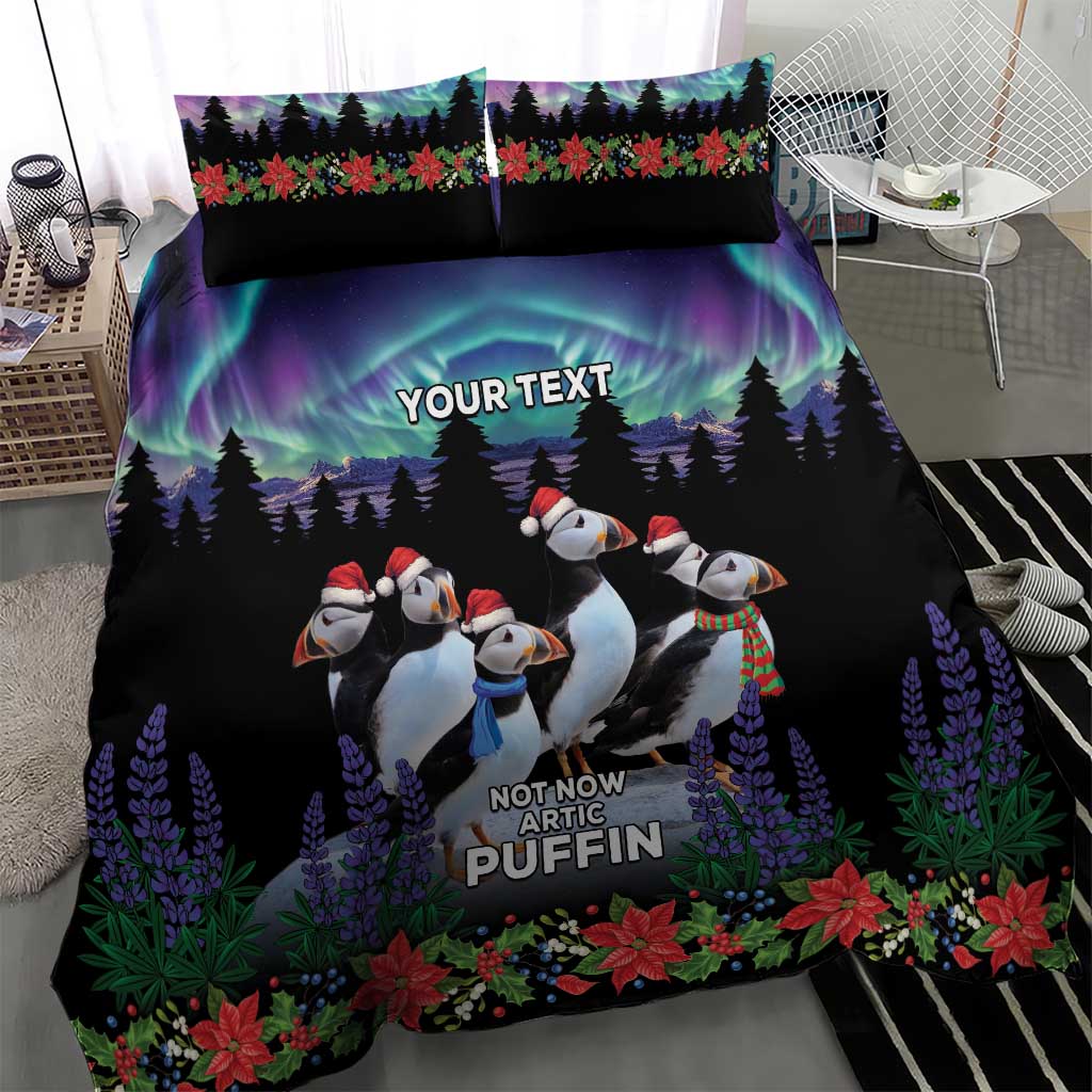 Close view of black duvet cover with arctic puffin penguins, purple trees and flower border