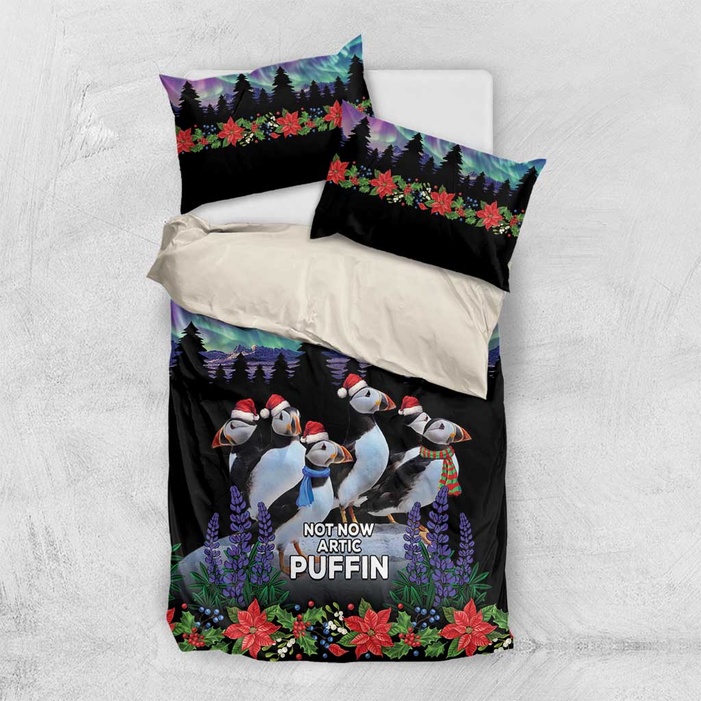 Bedding set with black duvet and two pillowcases featuring arctic puffin penguins and poinsettias