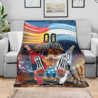 Blue football blanket on gray sofa with '00 YOUR TEXT' and two cartoon players