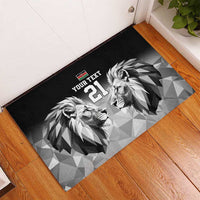 Black rubber doormat with geometric lions, Kenya flag emblem, and '21' near doorway