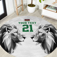 Round carpet with geometric lion faces and green '21' text, with Kenya flag at top