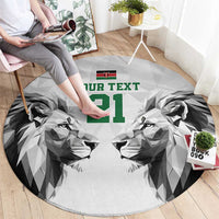 Round carpet with geometric lion faces, green '21' text, and small Kenya flag
