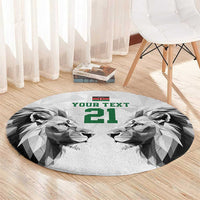 Round carpet with geometric lion faces and green '21' text, on light gray background