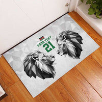 White rubber doormat with two lion heads, green “YOUR TEXT” and number 21, corner view.