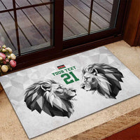 White rubber doormat with two lion heads, green “YOUR TEXT” and number 21 at entrance.