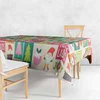 Christmas tablecloth with multicolor Yule lads figures, trees, and gift icons across the top
