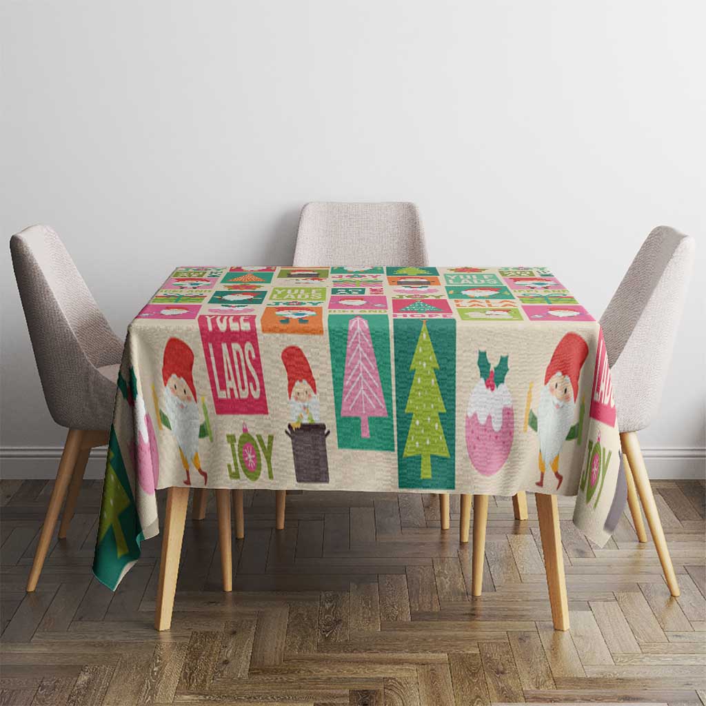 Colorful Christmas tablecloth showing Yule lads, joy lettering, trees, and whimsical characters