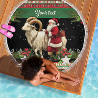 Personalized round beach blanket with Santa and goat illustration, green patterned border, fringe edge