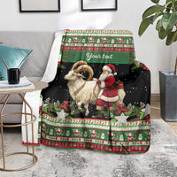 Personalized holiday blanket draped on chair, green and black with goat and Santa scene