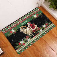 Green rubber doormat on hardwood floor with goat and Santa scene and festive border