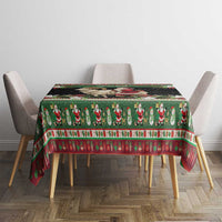 Green holiday tablecloth with goat and Santa, red patterned stripe