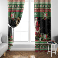 Green and black holiday curtain panels with ram goat and Santa, hung on a rod