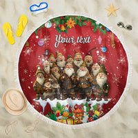 Red round beach blanket with fringe, festive gnomes and hanging-ornament border, 'Your text'.