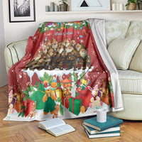 Personalized holiday blanket with red festive scene of gnomes, gifts, and rabbits, draped on a couch