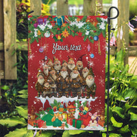 Red personalized garden flag with Santa gnome group, gifts, and snow on garden stake