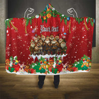 Red hooded blanket with You're tent text, Santa figures, and colorful gifts