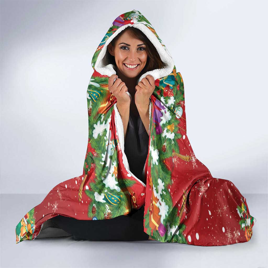 Red hooded blanket with colorful holiday print and white sherpa hood lining