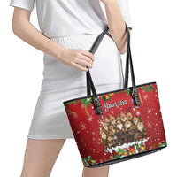 Red leather tote bag with black handles held in hand; festive gnome graphic and 'Your text' label