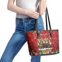 Red leather tote bag on person with black handles and zipper; festive gnome scene and 'Your text'